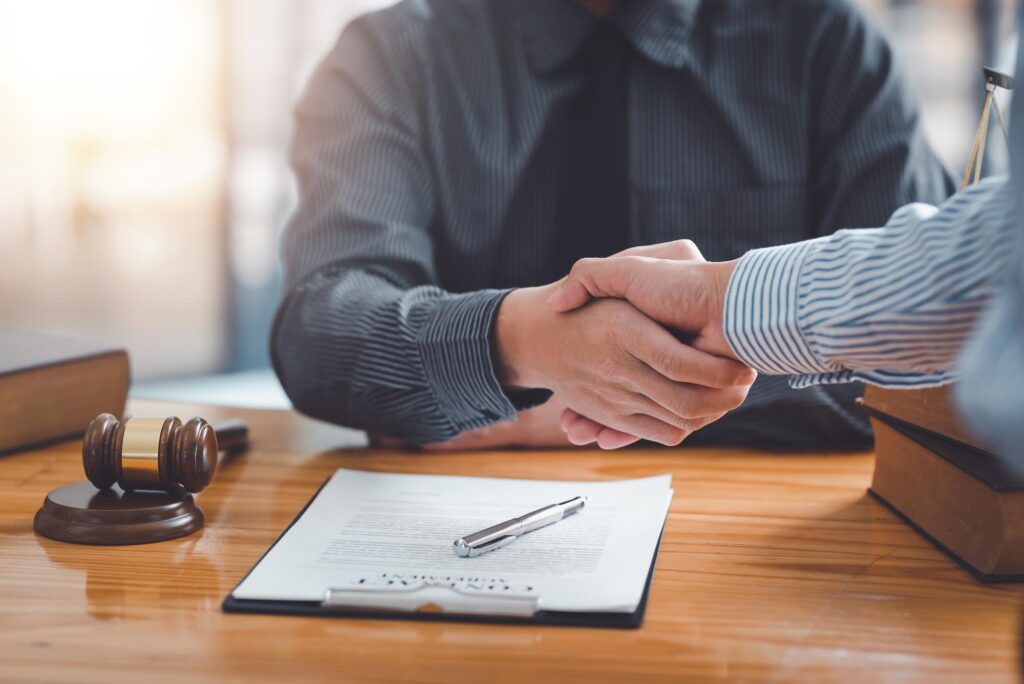 Businessman handshake partner lawyers or attorneys discussing a contract agreement. Business people shaking hands to congratulate success.